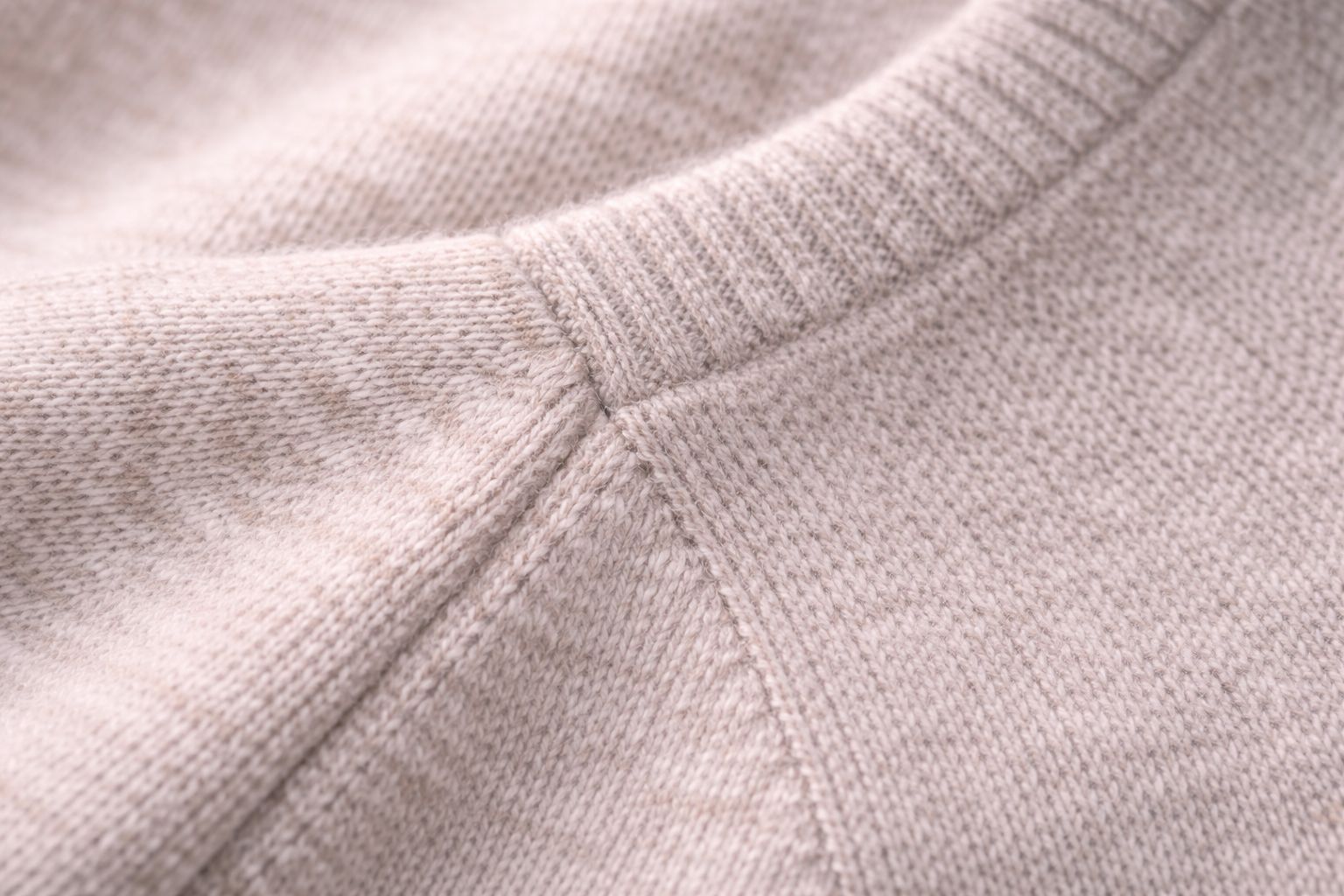 Close-up of a fully-fashioned sweater seam, showing structural integrity.