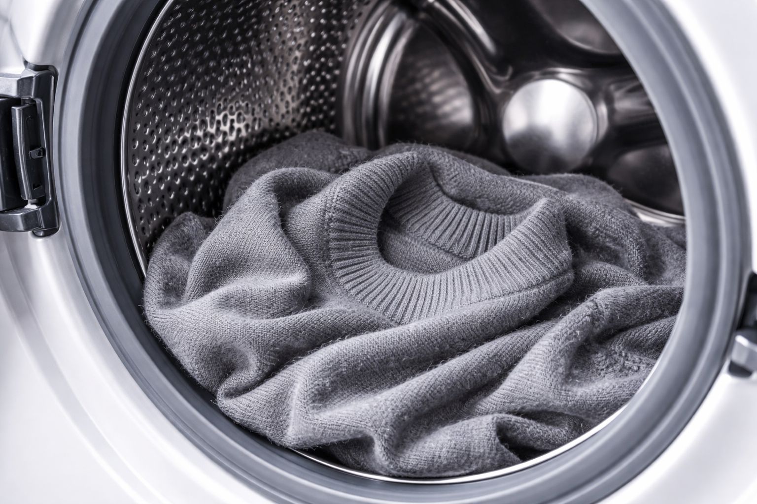 A wool sweater inside a modern washing machine drum