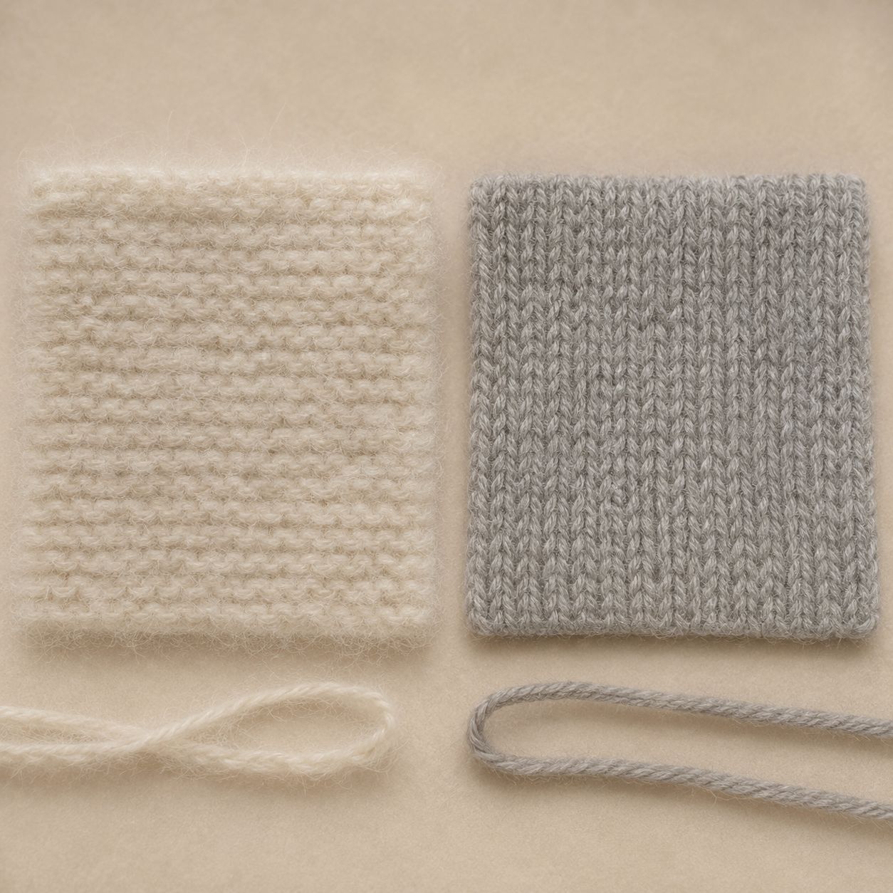 A close-up comparison of sheep wool fibers and cashmere goat undercoat fibers, shown as soft textile samples and yarn strands on a beige background