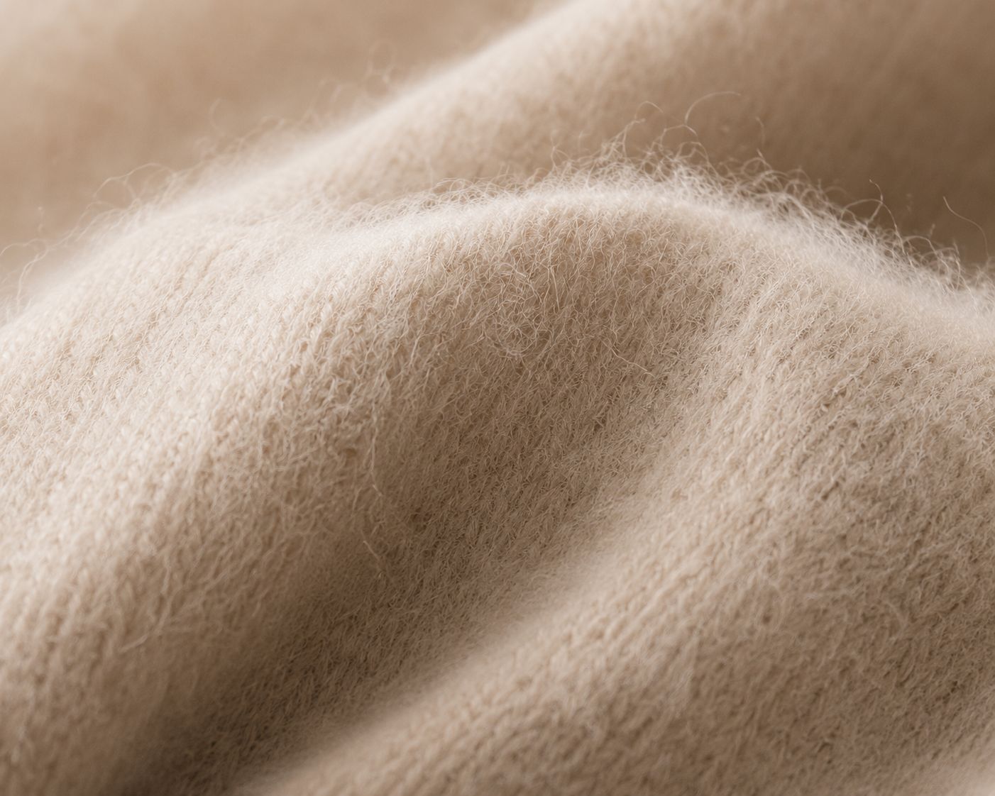 A close-up shot showing the lofty, airy fibers of a cashmere sweater trapping warmth.