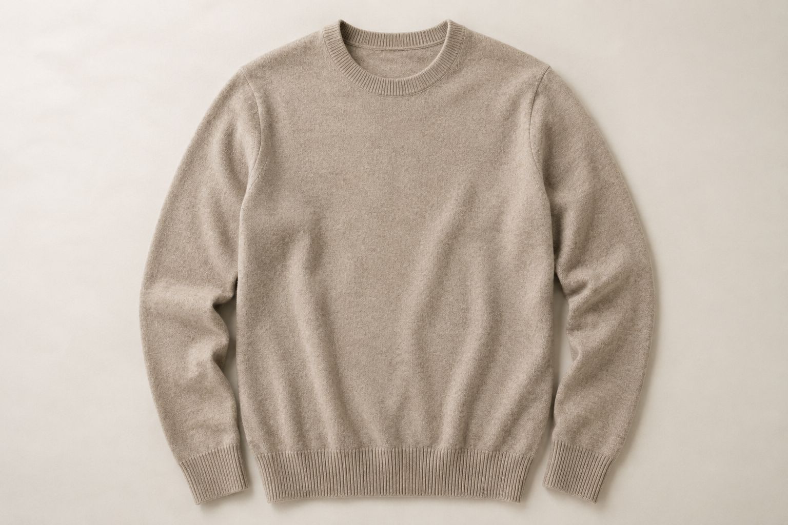 A luxuriously soft Merino wool sweater, professionally flat-laid to highlight its texture.